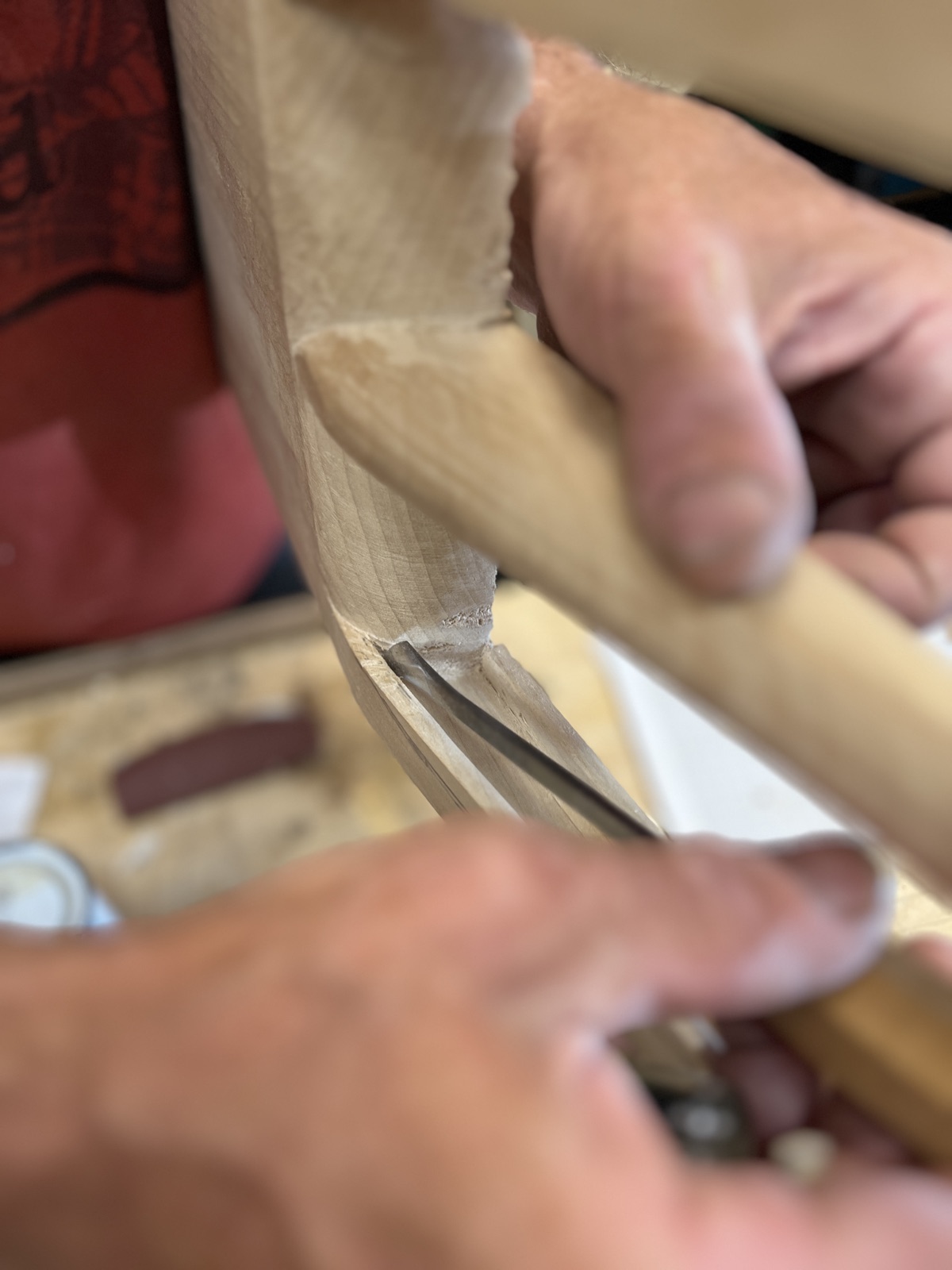 Hands at the workbench, shaping wood