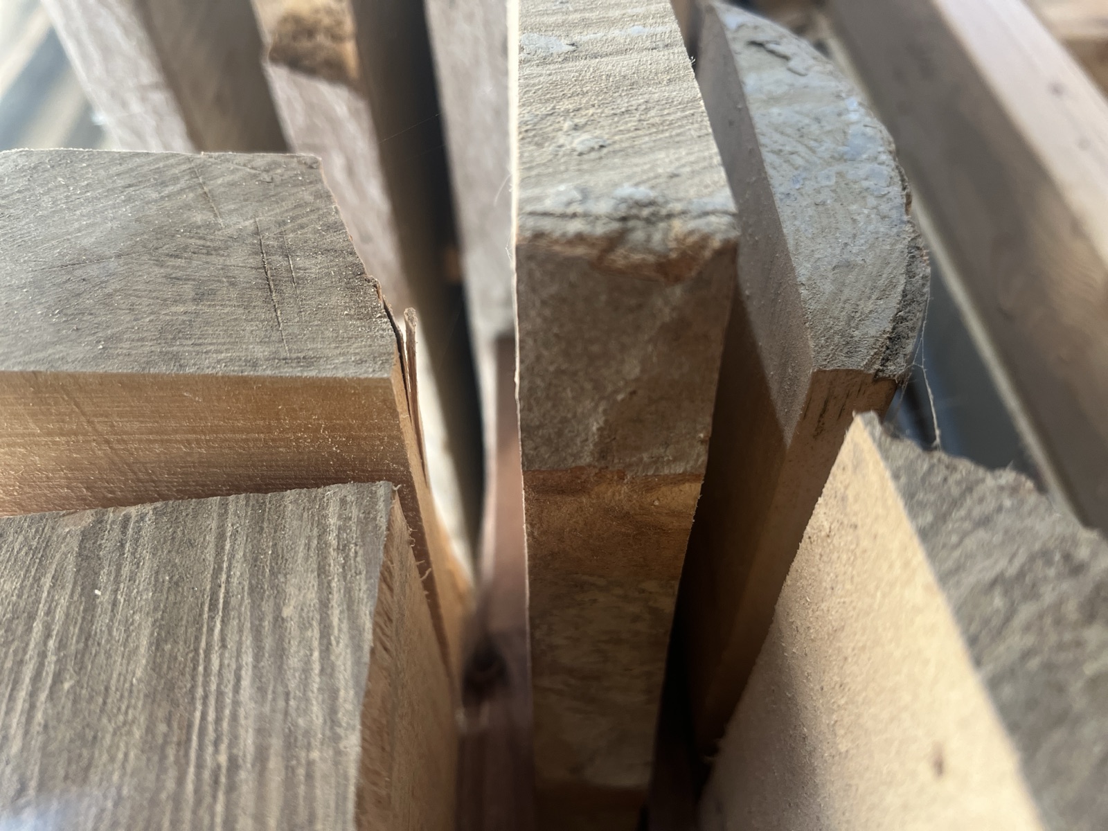 Rough-sawn Welsh timber stacked in the workshop
